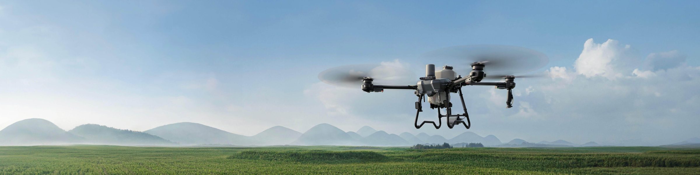 An enterprise drone in flight over open farmland